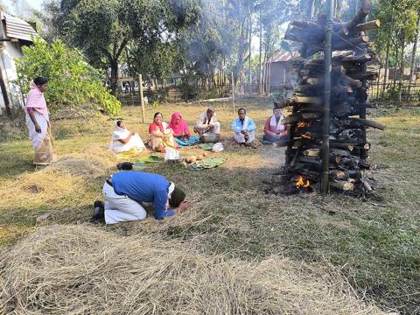 Praying at the Meji bonfire on Magh Bihu